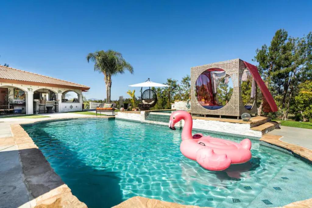 a swimming pool with a pink flamingos in the water at MAGIC VILLA Overlooking Pool Oasis in Temecula