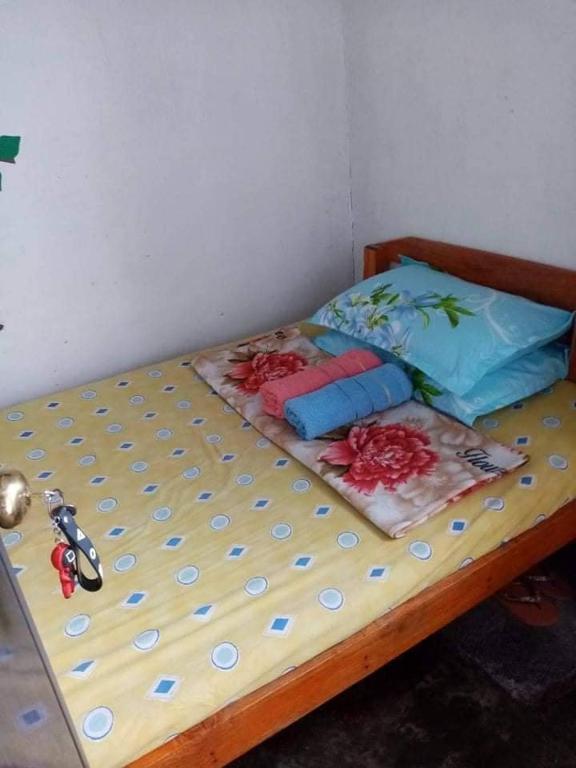 a bed with two pillows on it in a room at Yem Homestay in Baguio