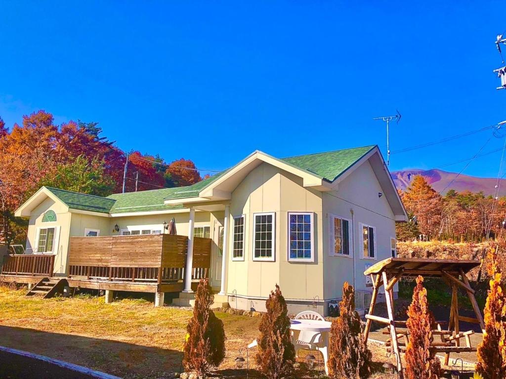 a small house with a porch and a deck at Polar House NishiKaruisawa2 - Vacation STAY 00265v in Oiwake