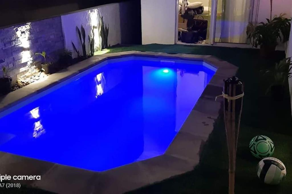 a blue swimming pool with a soccer ball next to it at Riverwalk Villa 
