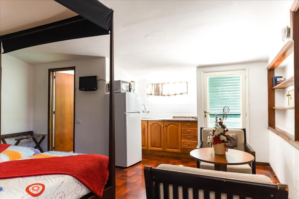 Postel nebo postele na pokoji v ubytování Residencial Colombo