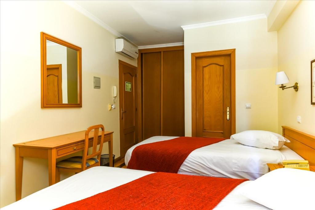 Postel nebo postele na pokoji v ubytování Residencial Colombo