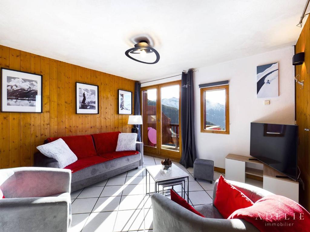 a living room with a red couch and chairs at Appartement Montvalezan-La Rosière, 5 pièces, 8 personnes - FR-1-398-644 in Montvalezan