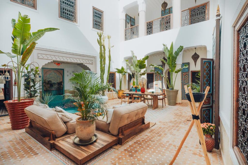 a living room filled with furniture and lots of plants at Kenzara Suites & Pool, Your private escape in Marrakesh