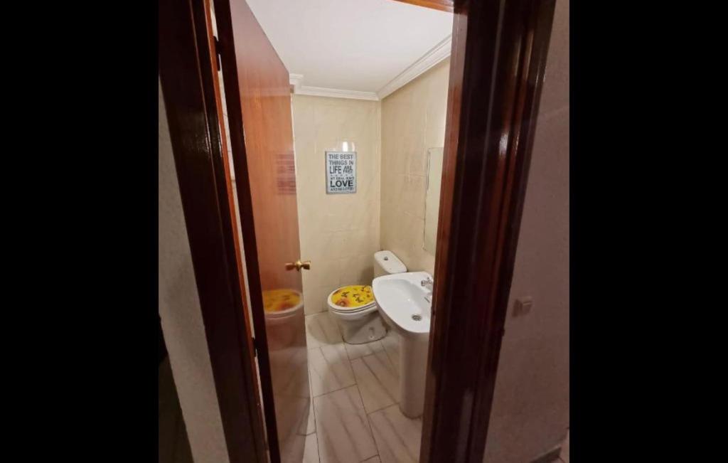 a bathroom with a toilet and a sink at BE LIKE AT HOME PARIS in Alcalá de Henares