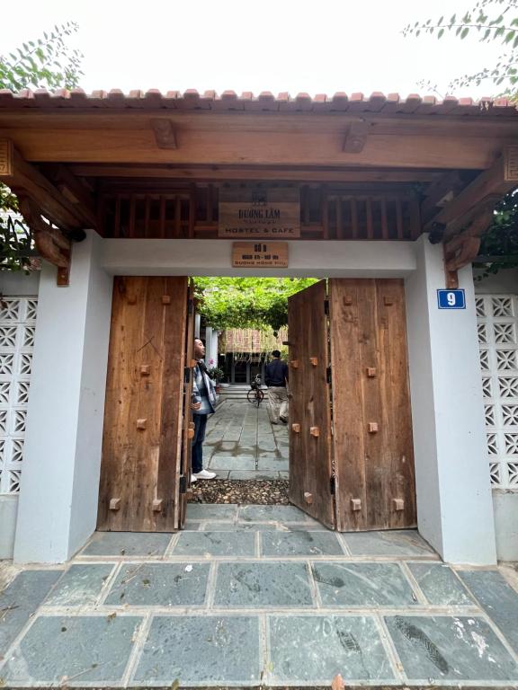 an entrance to a building with wooden doors at Đường lâm village homestay in Yên Vệ