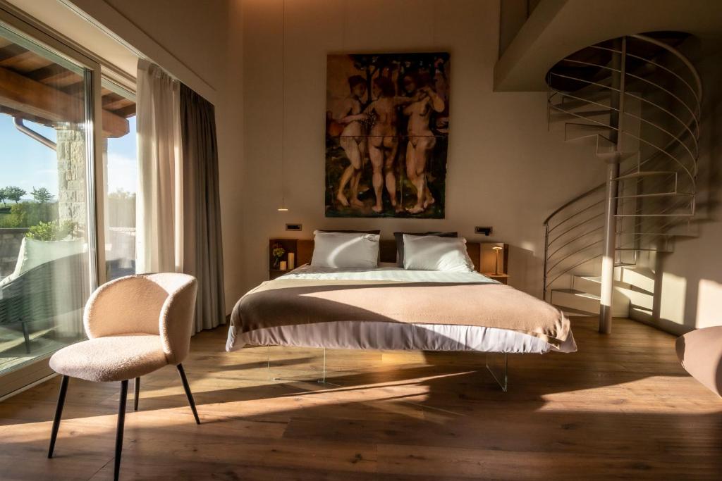 A bed or beds in a room at Borgo Corsignano