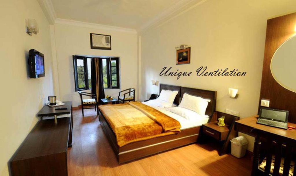 a bedroom with a large bed with a sign on the wall at Hotel Hong Kong Inn in Amritsar