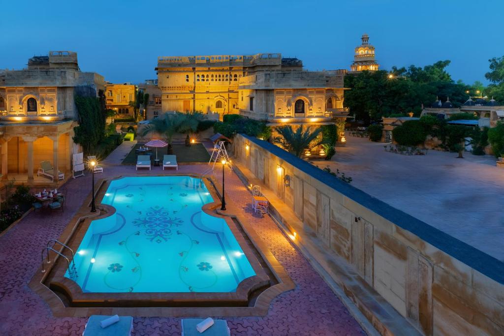 a view of a pool from a building at night at WelcomHeritage Mandir Palace in Jaisalmer