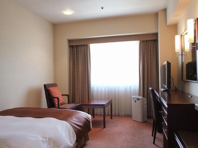 Postel nebo postele na pokoji v ubytování Fukuyama New Castle Hotel