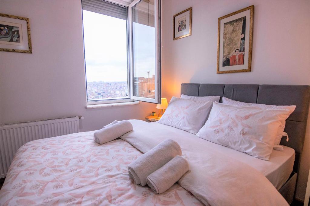 A bed or beds in a room at Taksim Roya Apartment -center of the Istanbul