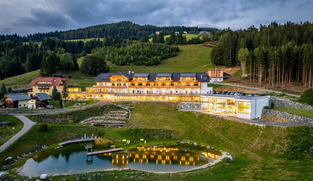 an aerial view of a large building on a hill at Familienhotel Petschnighof in Diex