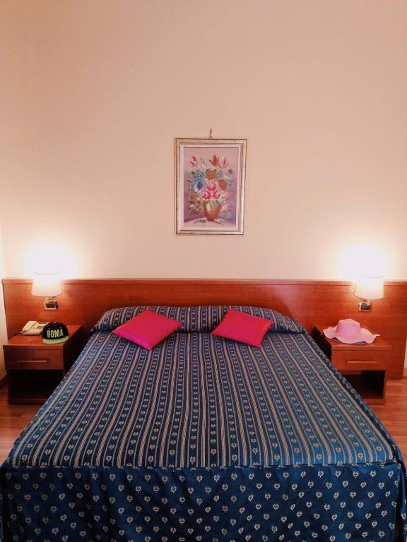Postel nebo postele na pokoji v ubytování Hotel Fenicia