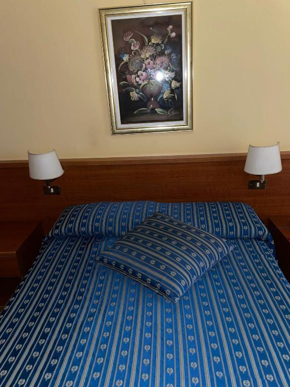 Postel nebo postele na pokoji v ubytování Hotel Fenicia