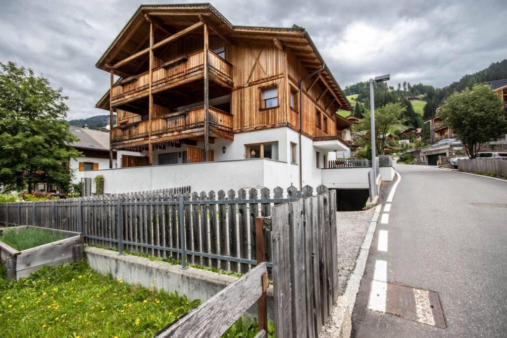 a wooden house on the side of a road at Casa Ami in Sesto