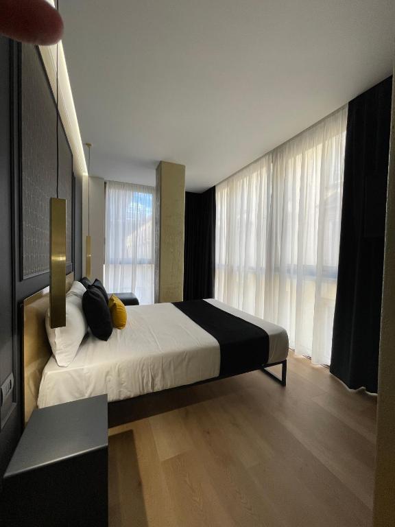 Łóżko lub łóżka w pokoju w obiekcie Plebiscito Boutique Rooms