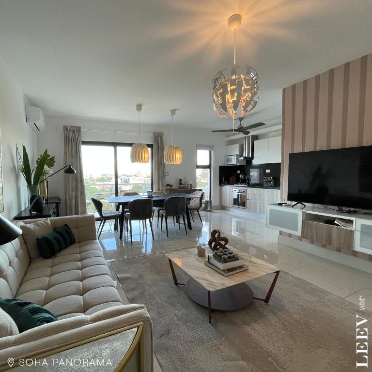 a large living room with a couch and a table at Soha panorama- A14- 2 dormitorios in Santiago de los Caballeros