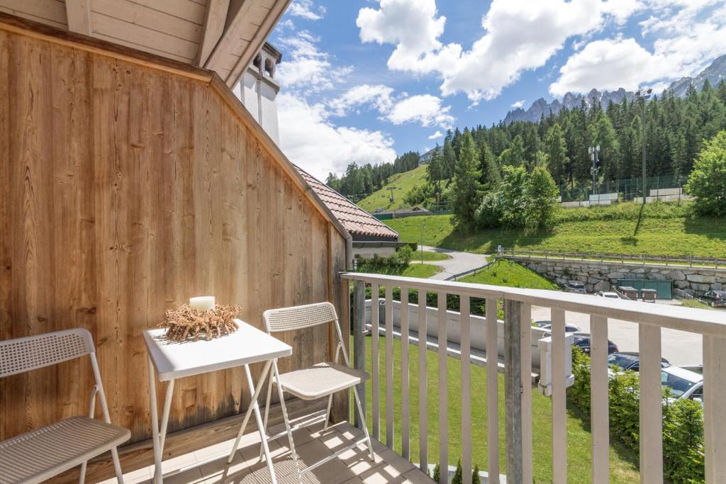 a balcony with two chairs and a table with a view at Casa Serena in San Candido
