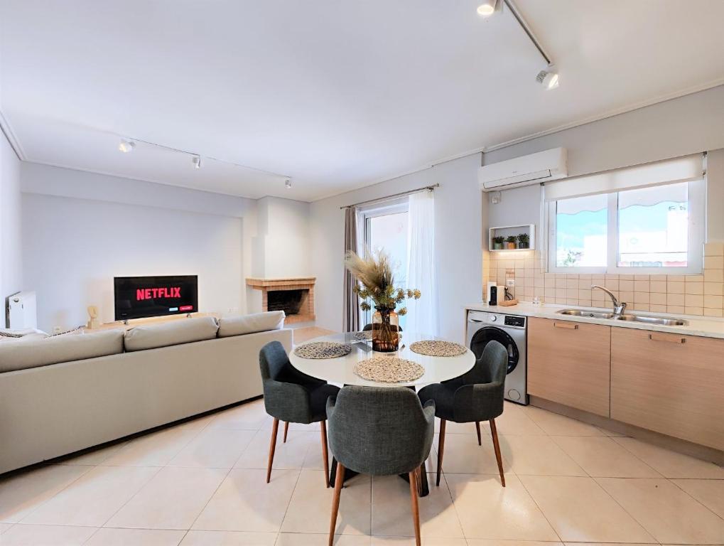 a kitchen and living room with a table and chairs at Nefelis C2 by Verde Apartments in Athens