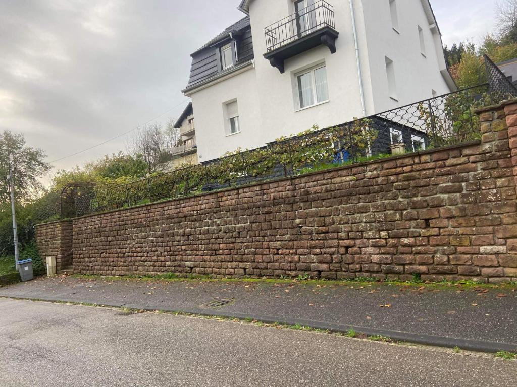 a brick wall in front of a building at Appartement Les Tilleuls &quot;3 étoiles&quot; in Niederbronn-les-Bains