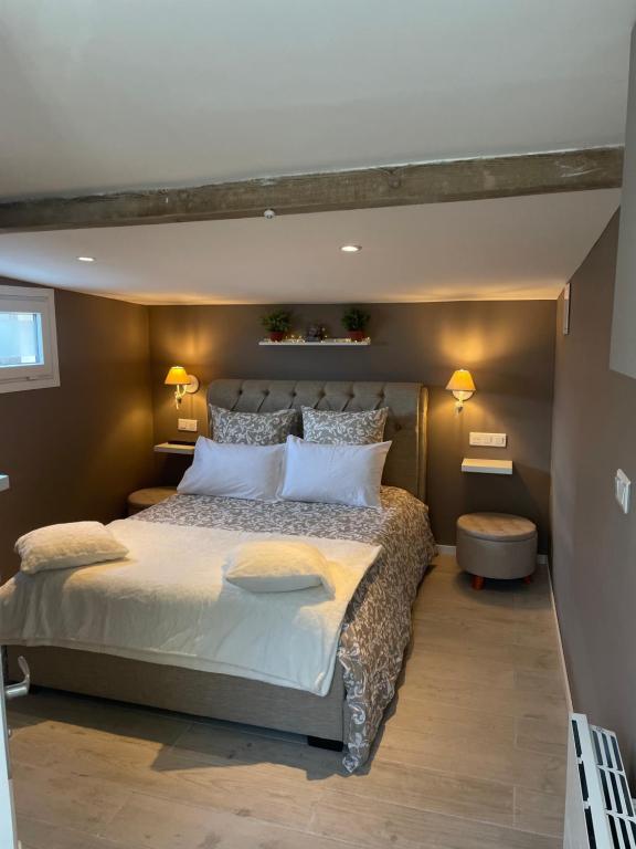 a bedroom with a large bed with white pillows at Le cocon in Dieppe