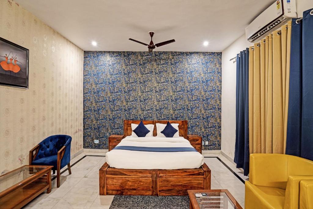 a bedroom with a bed and a blue wall at Jain Residency in Greater Noida