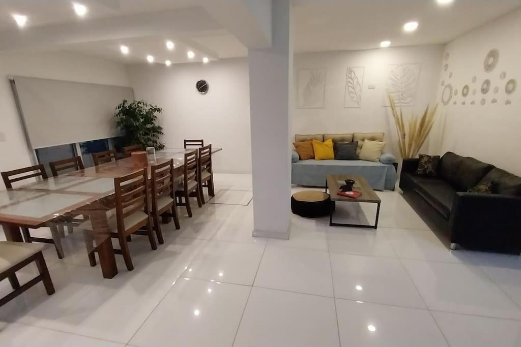 a living room with a table and a couch at Casa con pileta mirador de cabildo in La Punta