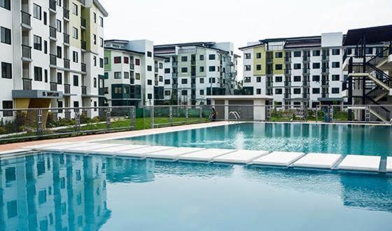 a large swimming pool in front of some buildings at 2 BR staycation beside Enchanted Kingdom in Santa Rosa