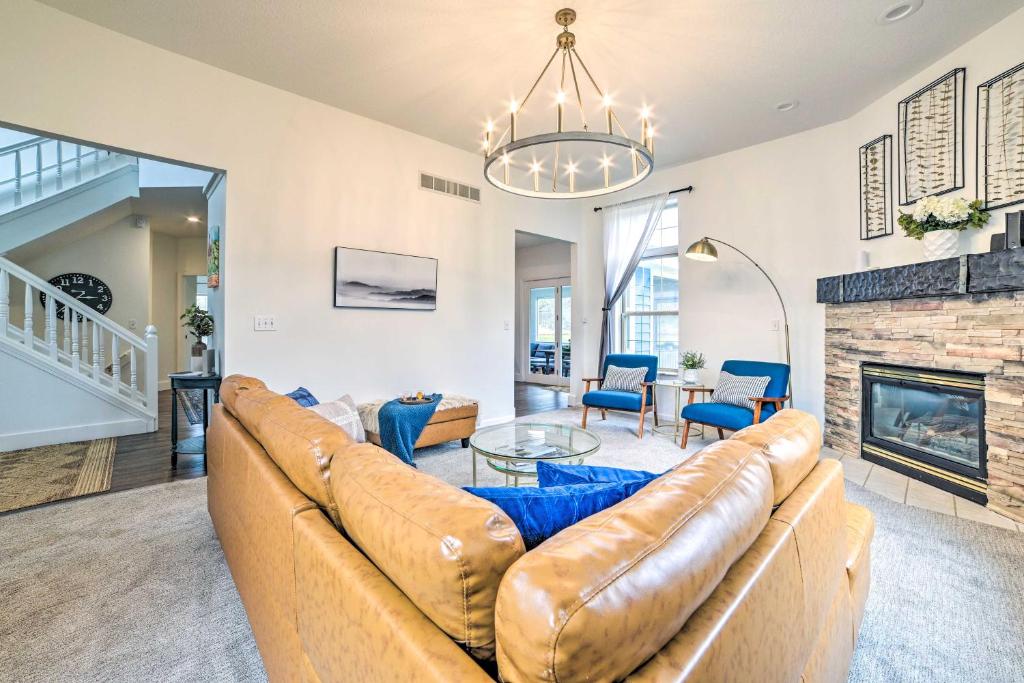 a living room with a couch and a fireplace at Game Room and On-Site Snow Trails! Bellaire Retreat in Bellaire