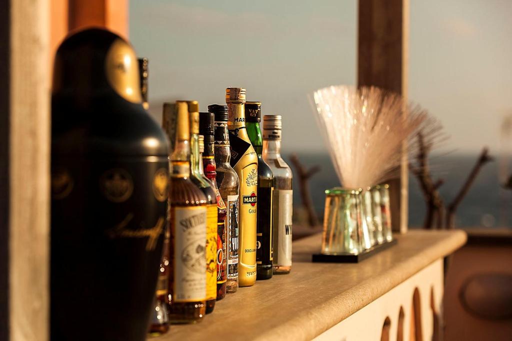 a row of bottles of alcohol sitting on a counter at Hotel Nettuno in Ischia
