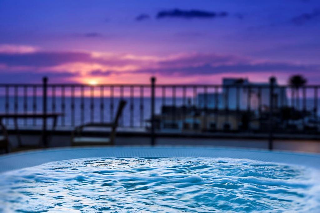 a tub of water with the ocean in the background at Hotel Nettuno in Ischia