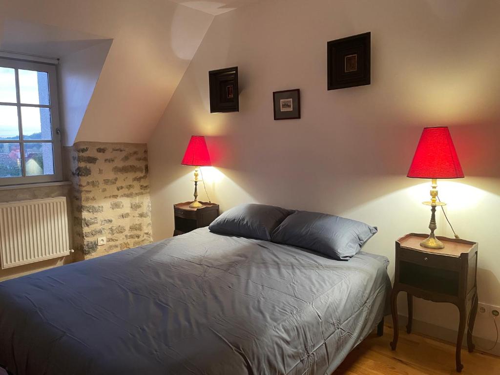 - une chambre avec un lit et 2 lampes dans l'établissement Le jardin du roitelet, à Semur-en-Auxois