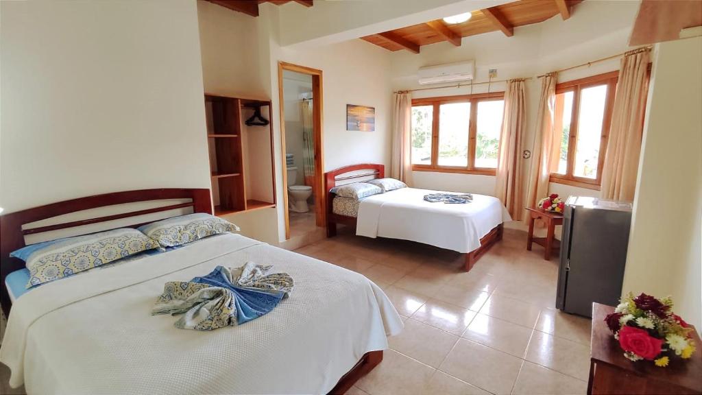 Postel nebo postele na pokoji v ubytování Hotel Cielo Azul