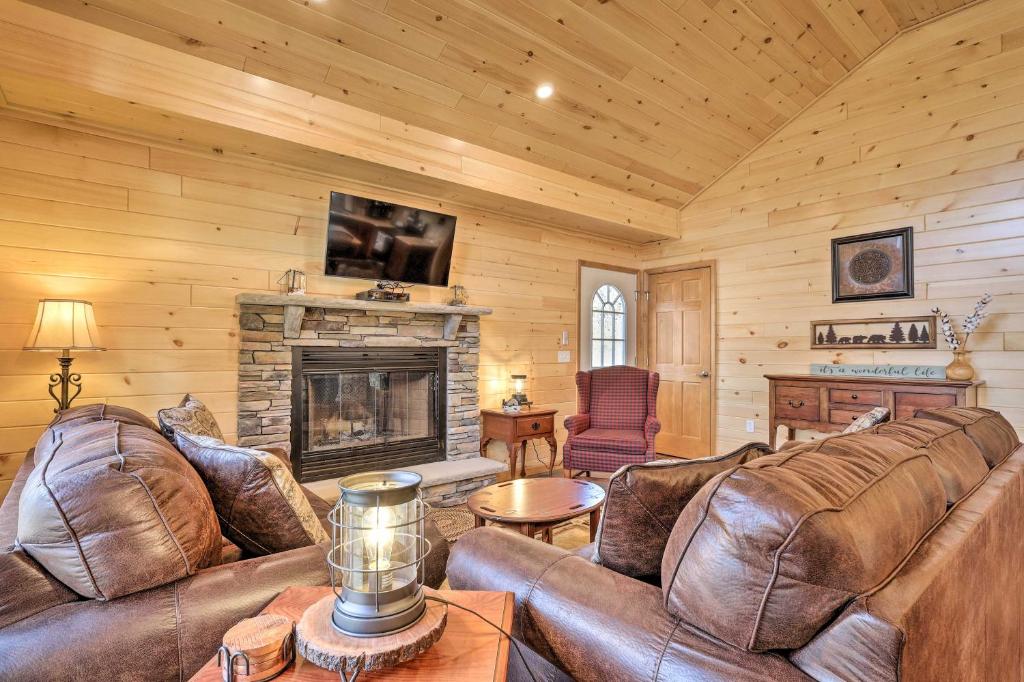 a living room with leather furniture and a fireplace at Chestertown Hideaway with Lake and Beach Access! in Chestertown