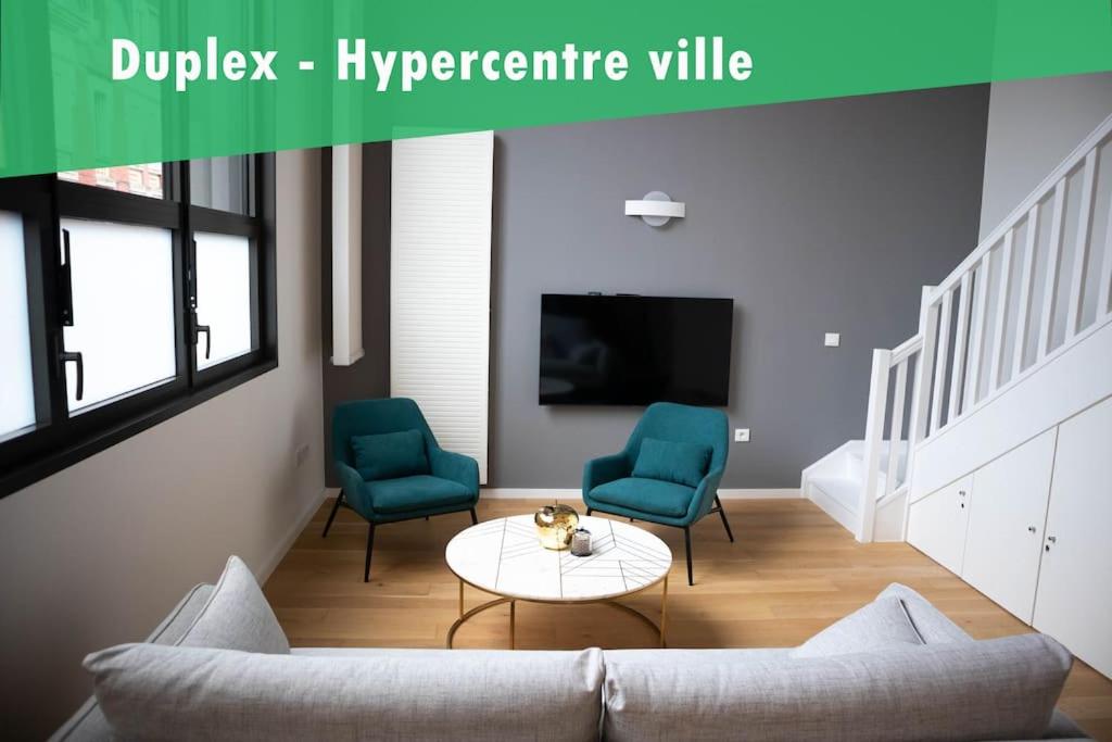 a living room with a couch and two chairs and a tv at Superbe duplex en hypercentre ville in Amiens