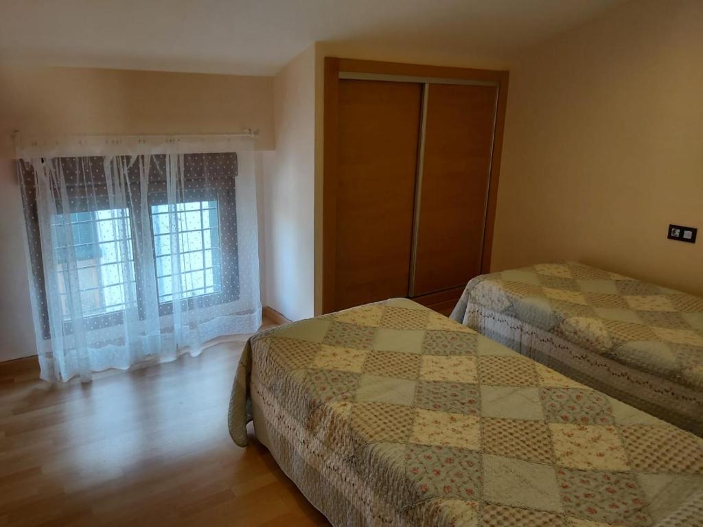 una camera da letto con due letti e una finestra di Casa rural Sofia a Puebla de Don Fadrique