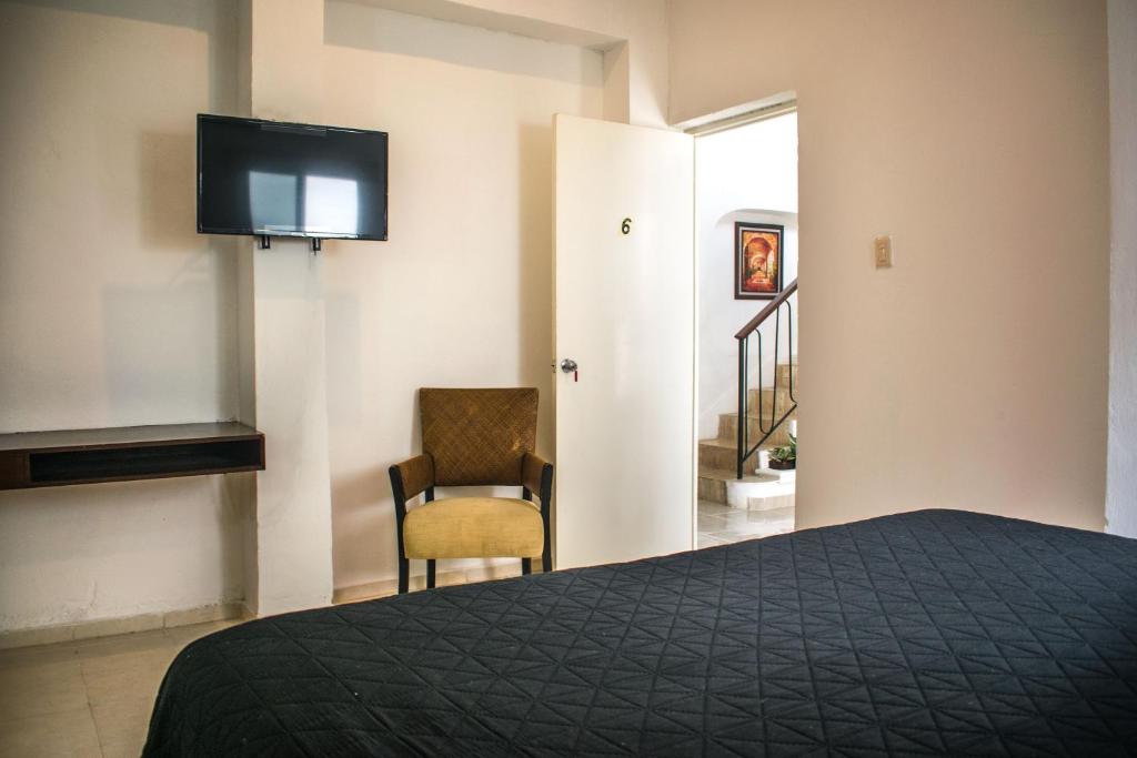 Postel nebo postele na pokoji v ubytování Hotel Cupules