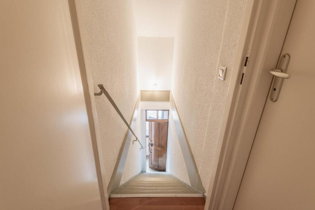 a stairway leading up to a hallway in a building at Pleasant apartment three minutes from the center of Annecy in Annecy