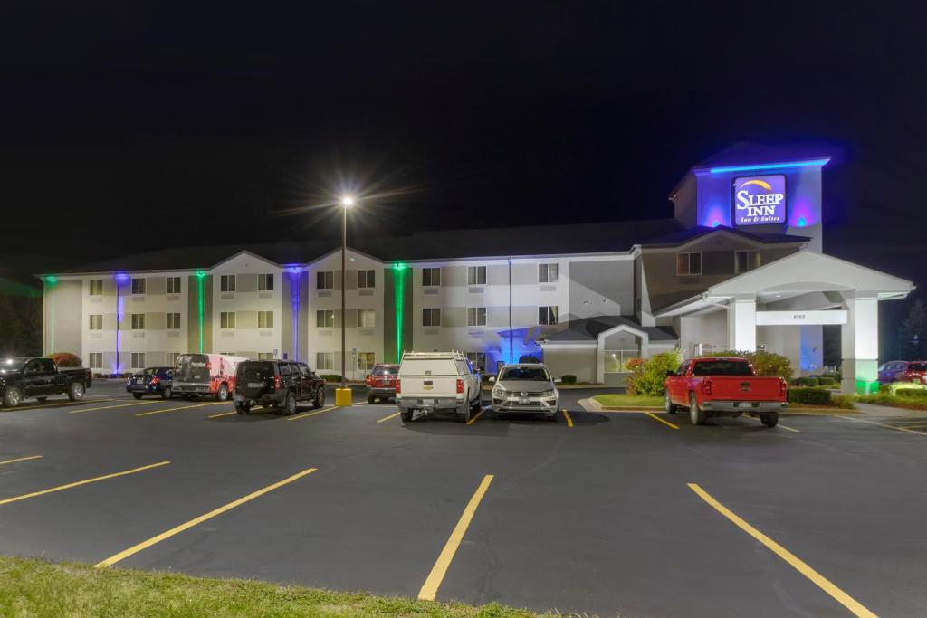 a parking lot in front of a hotel at night at Sleep Inn & Suites Allendale in Allendale