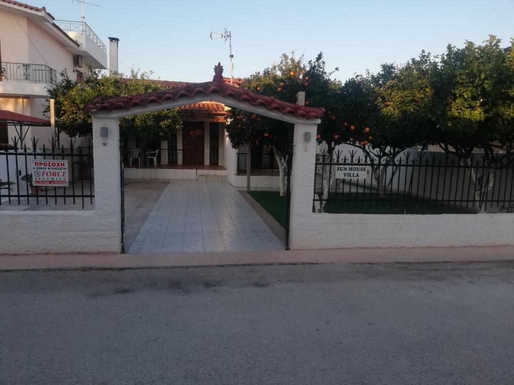 a gate to a building with a sign on it at Sunhouse Vrachati in Vrahati