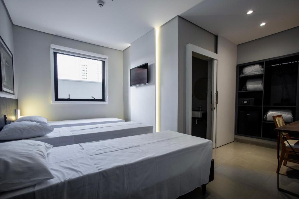 Postel nebo postele na pokoji v ubytování LA HOTEL VOTUPORANGA