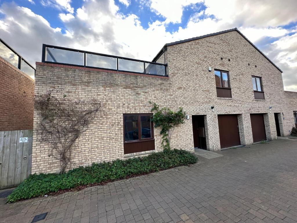 a brick building with a glass roof on it at 2 Bedroom Riverside Property with Roof Terrace in Stockton-on-Tees