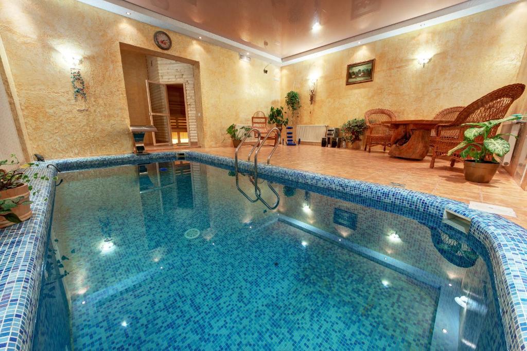 a large swimming pool in a house with a large at Sofia in Yaremche