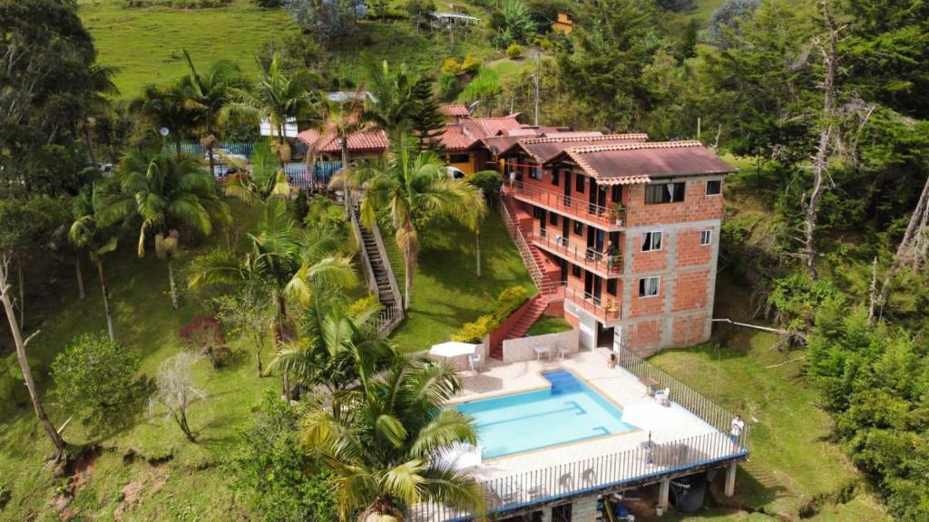- une vue aérienne sur une maison avec une piscine dans l'établissement HOTEL EL POTRILLO, à El Peñol