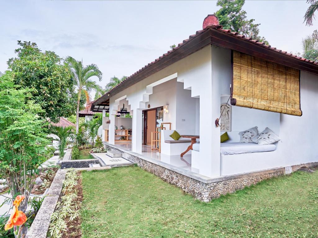 a villa with a garden and a resort at Anda Amed Villas & Spa in Amed