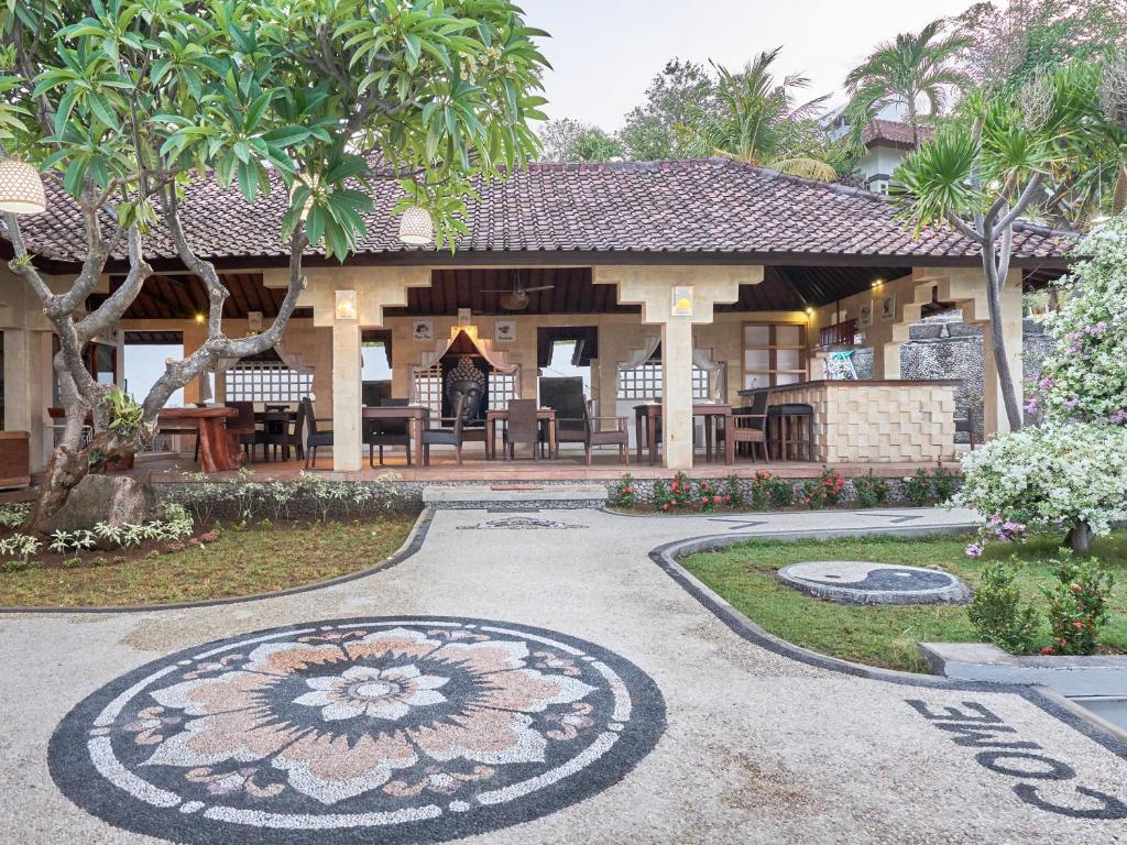 a house with a mandala on the ground in front of it at Anda Amed Villas & Spa in Amed