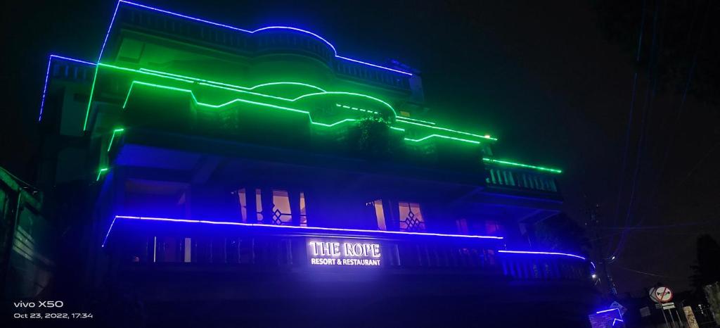 a building with green and blue lights on it at The Rope Resorts in Darjeeling