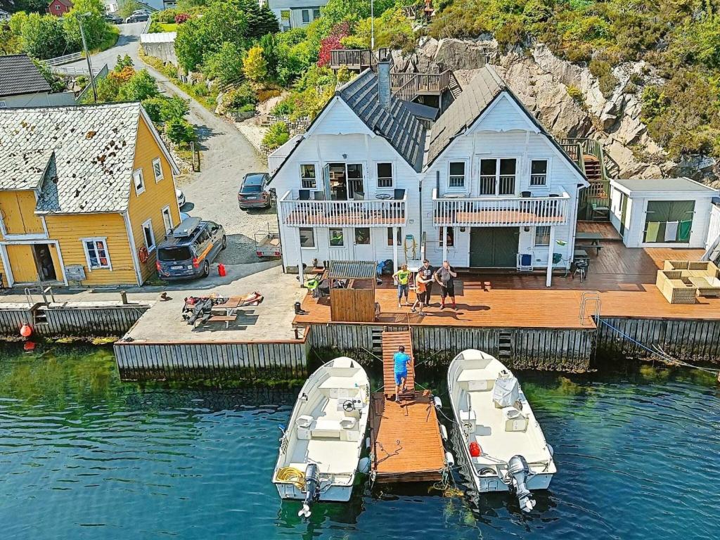 two boats are docked on a dock in the water at 6 person holiday home in Urangsvåg in Steinsbø