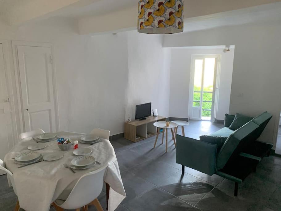 a living room with a white table and chairs at Greolières: Superbe Studio avec vue montagne in Gréolières