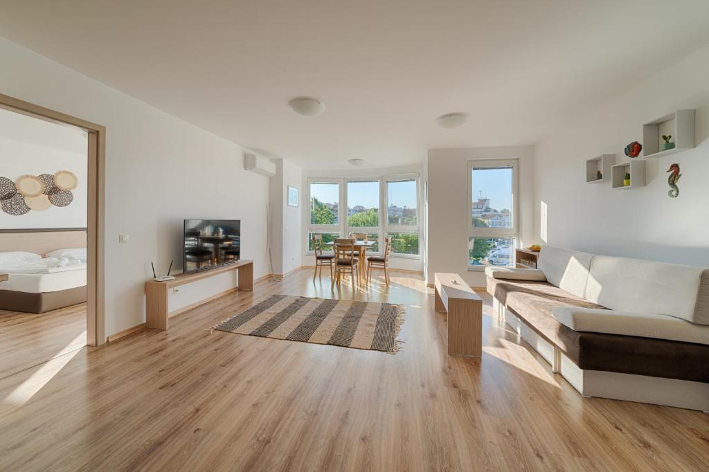 a living room with a couch and a table at Moana Fishermen Apartment in Ahtopol